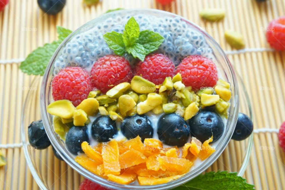 Smoothie Fresh Fruits Bowl - raspberry, blueberry,  mango, nuts and basil seeds