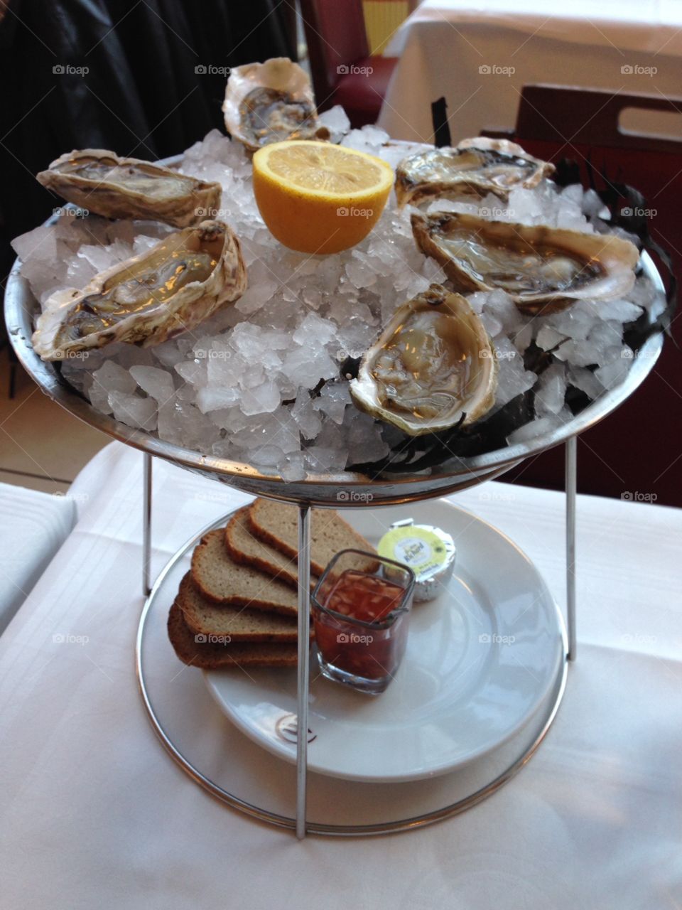 Fresh shucked Oysters . Oyster plate in Pigalle restaurant, Paris France