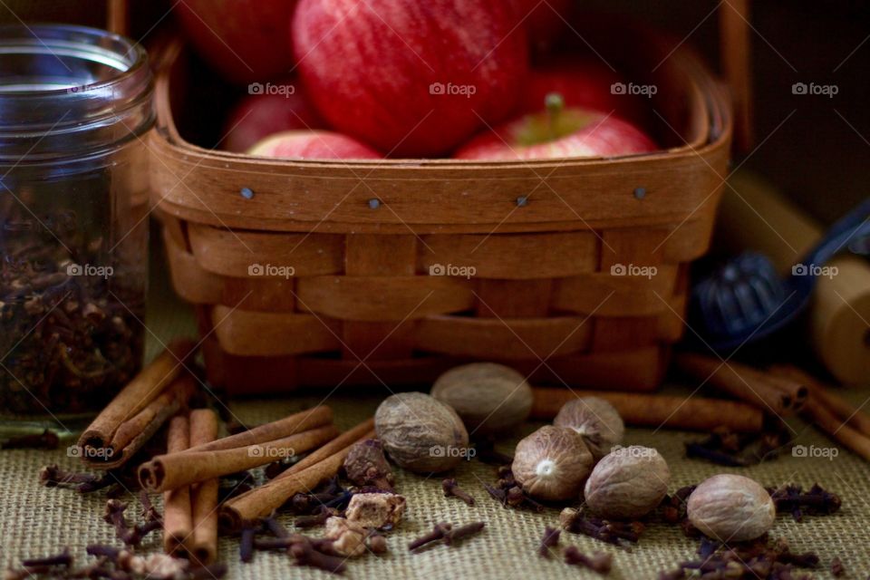 Whole spices, a small glass jar, apples in a basket, a pastry roller, and a vintage pie crust crimper on burlap  🍂🍎🍁
