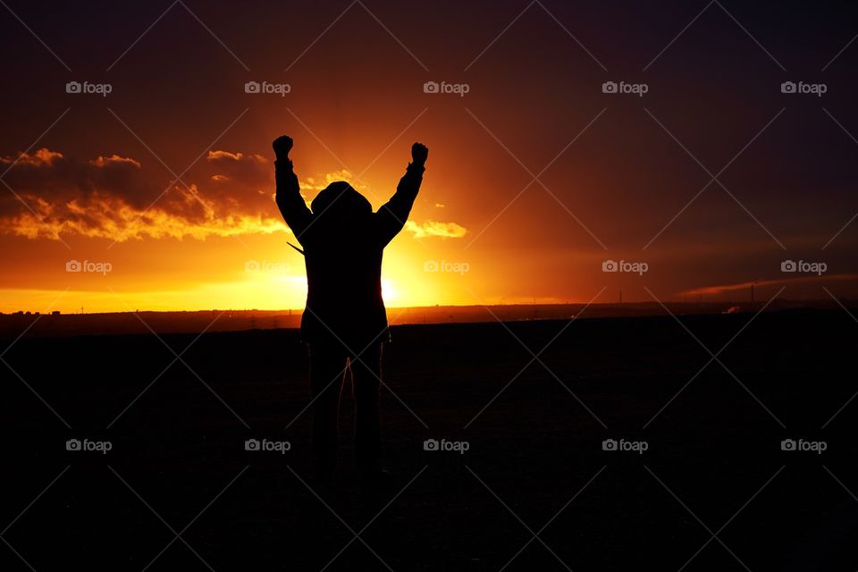 Man showing happines at sunset