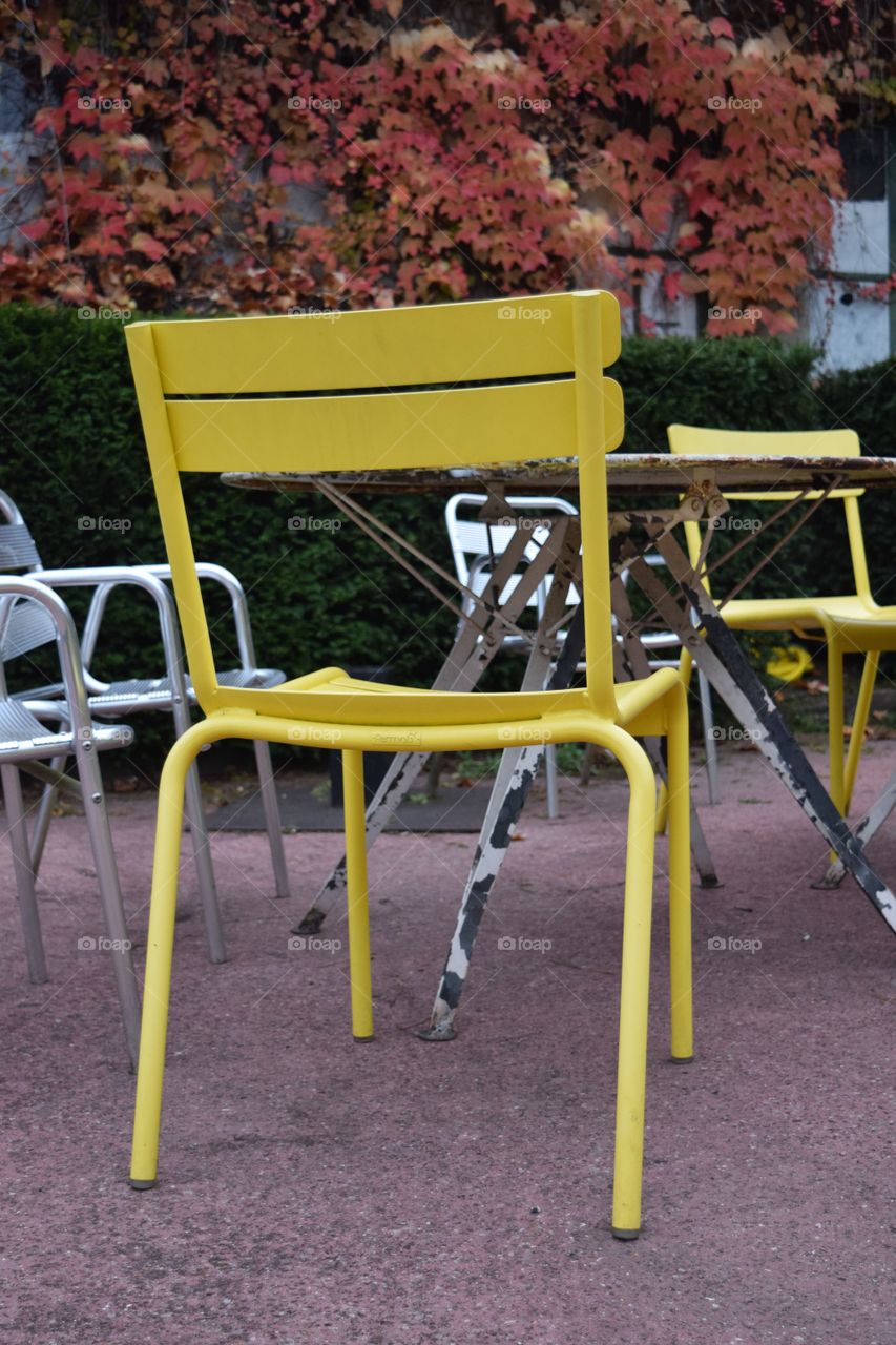 A yellow chair in a park in Paris. October 2016.