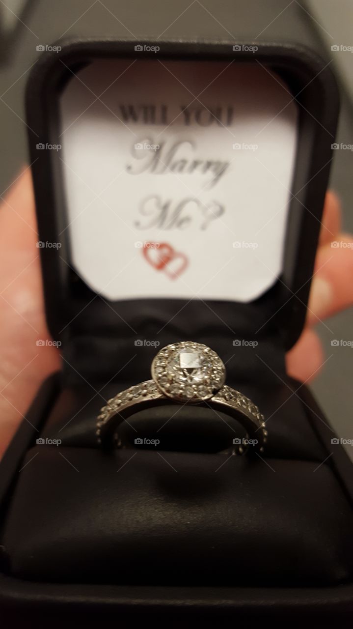 A proposal of marriage comes in a small box with an engagement ring.