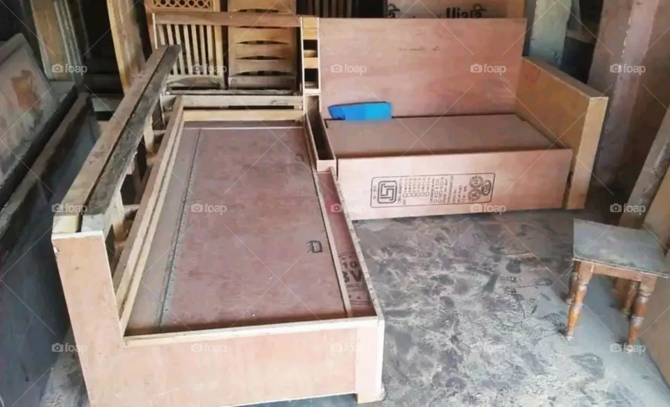 A carpenter building two new sofas.