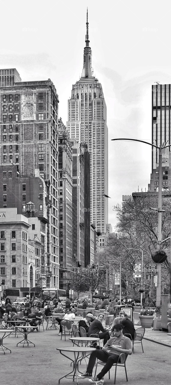 A Midtown Manhattan afternoon, with the Empire State Building in the background rendered in Black & White 