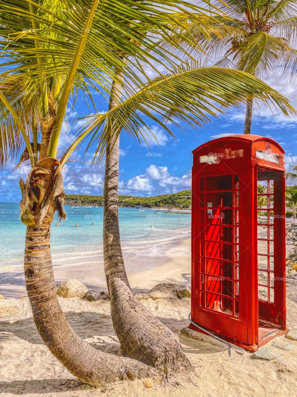 Red phone booth at the ocean