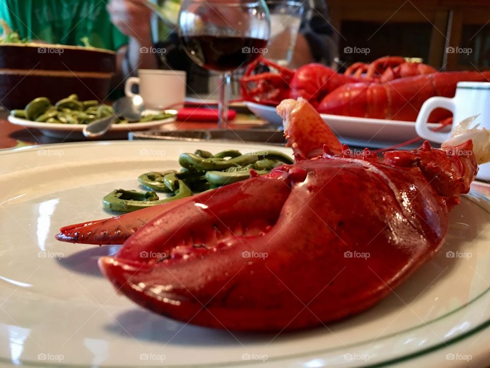 Red lobster tail on white dinner plate 