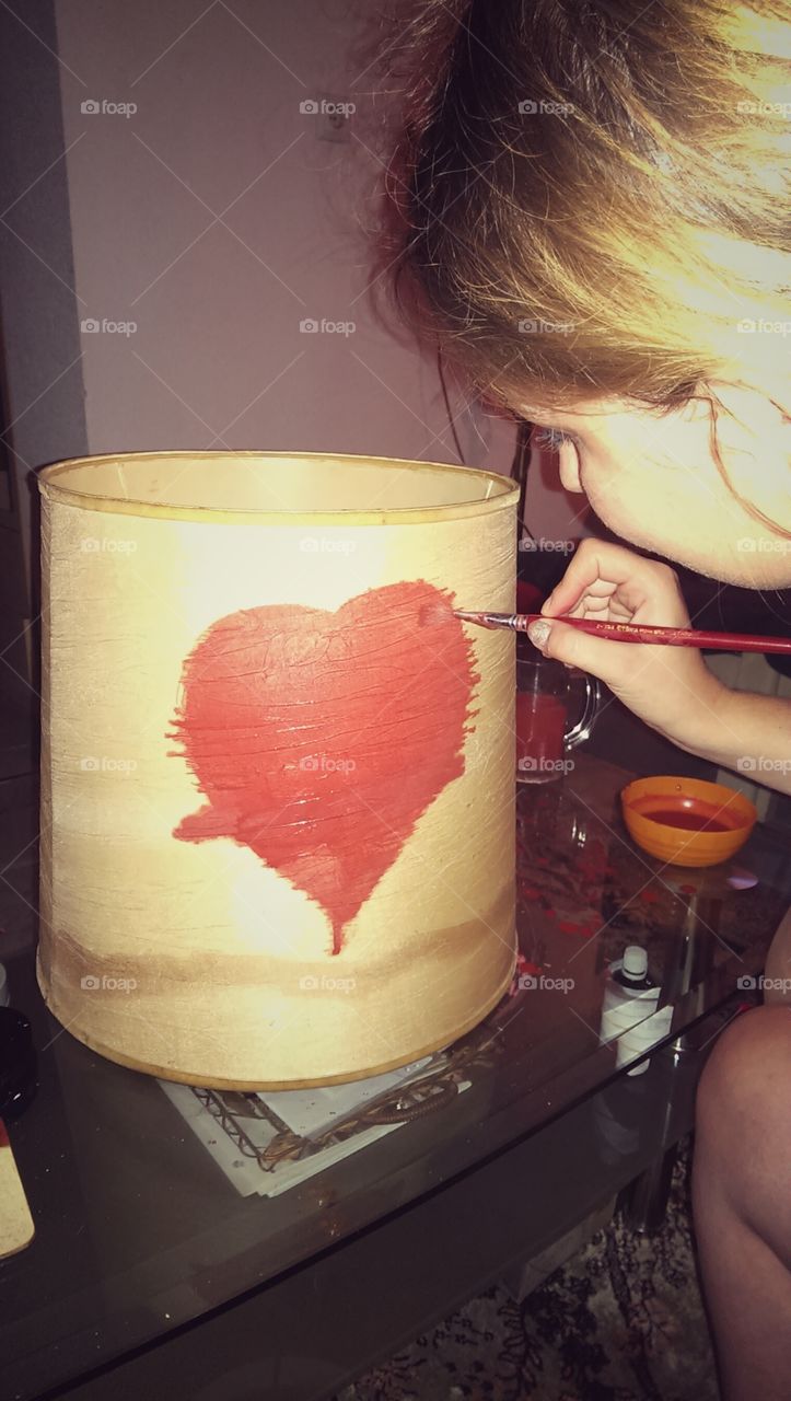 she is painting a part of lamp. love in lamp :)