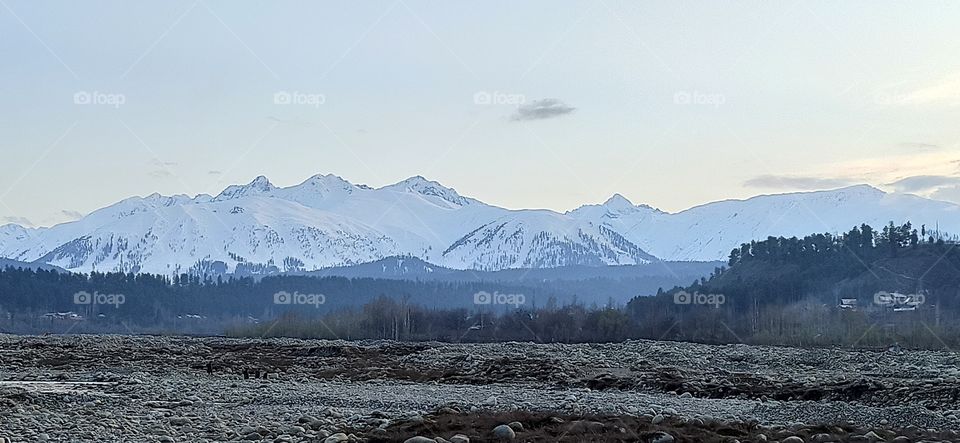 Snow Clad Mountains (during sun set time) along Pir Pangal Range Of Hirpora Shopian along Historic Mughal Road Shopian Snap taken at Rambi Sarah Nallah banks in Apple town ( Shopian ) Kashmir J&K.