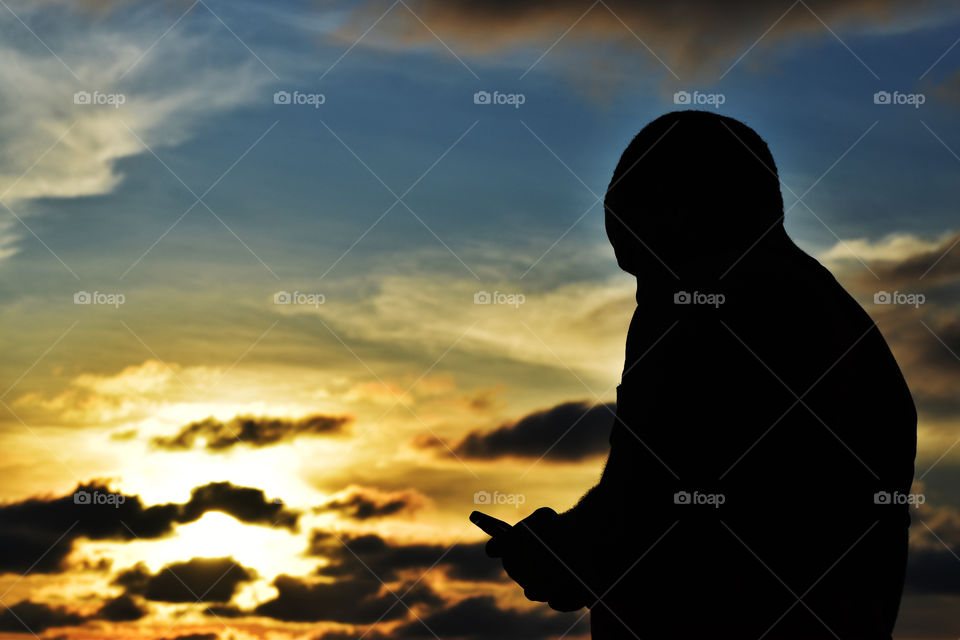 Silhouette of a man with an amazing sunset in the background