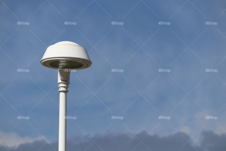 White modern lamppost lamp stand against vivid blue sky; minimalist, copy, text, graphic, quote, space. Perfect for wallpaper, icons, desktop, background. Conceptual image: destiny, pathway, motivation, help, idea, imagination, creativity, purpose, signal