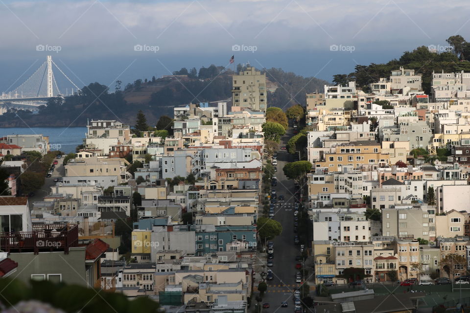 City streets , buildings and houses seen from top of the hill