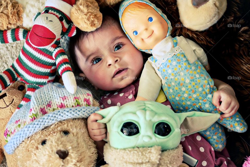 Baby girl plays in a pile of stuffed animals, baby loves playing with stuffed animals, dolls and stuffed animals for baby 