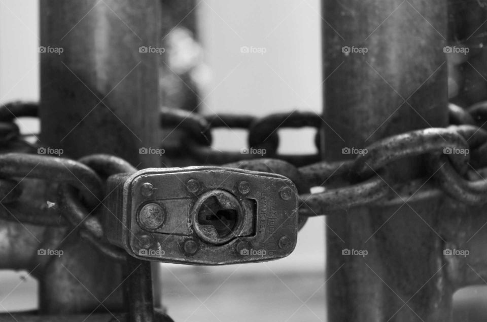 Black and White pad lock key hole and chain.