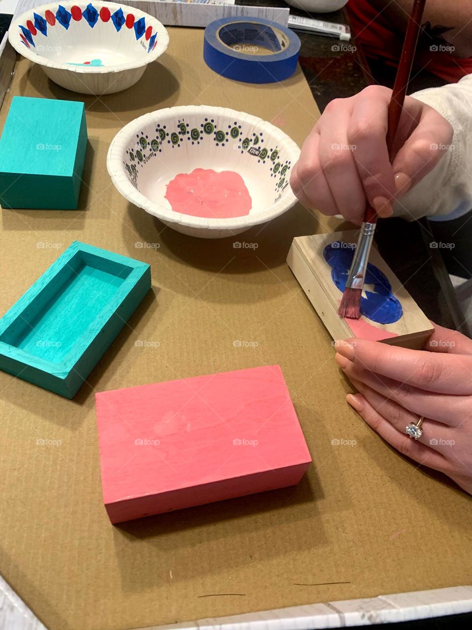 Person painting a homemade craft trinket box