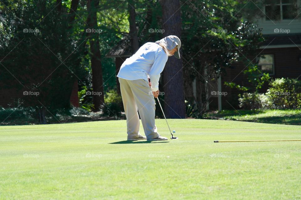 Man putting golf ball
