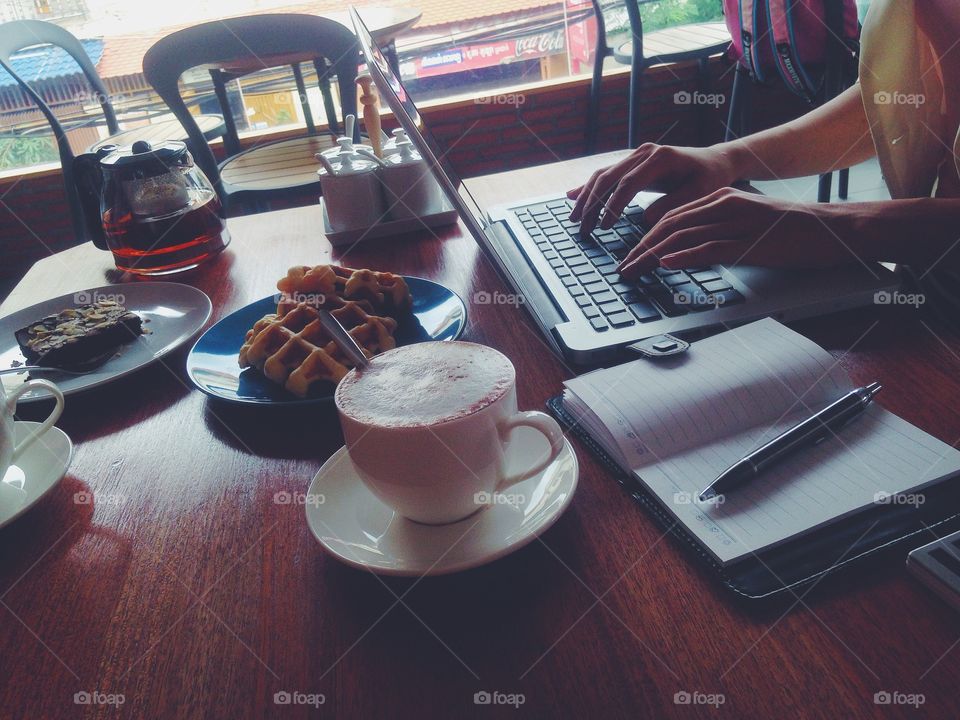 Woman working while having breakfast