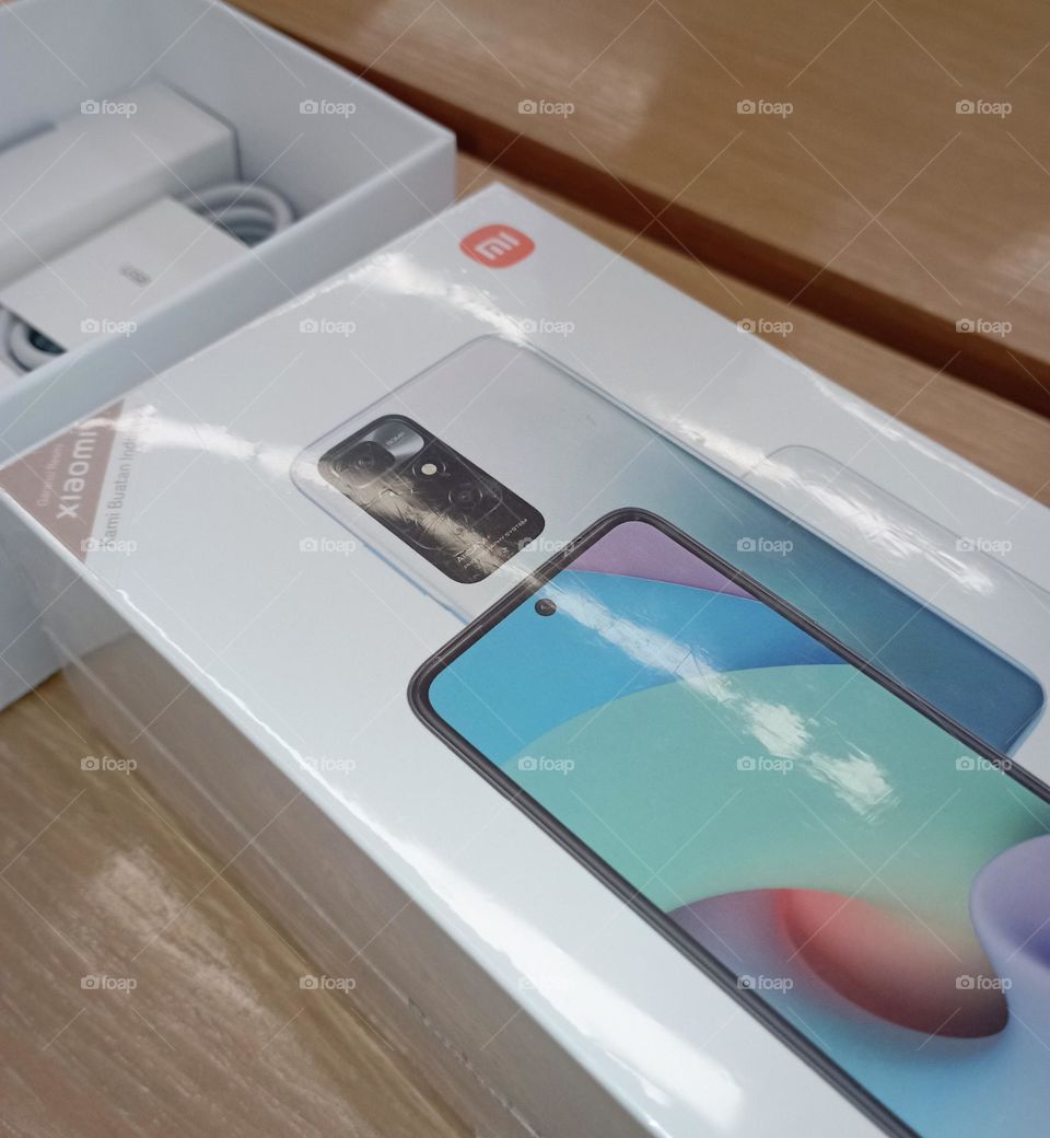 An opened cell phone box and charger...