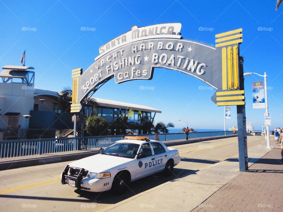 It looks like a screen from a detective movie. Police car passing the street in Santa Monica, Los Angeles.