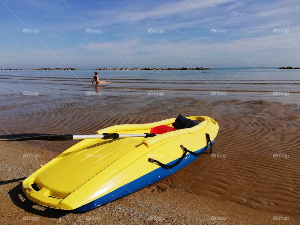 Yellow kayak on the shore