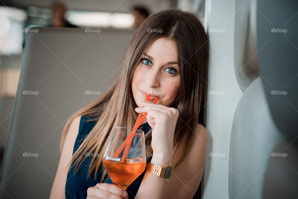 beautiful young woman drinking cocktail