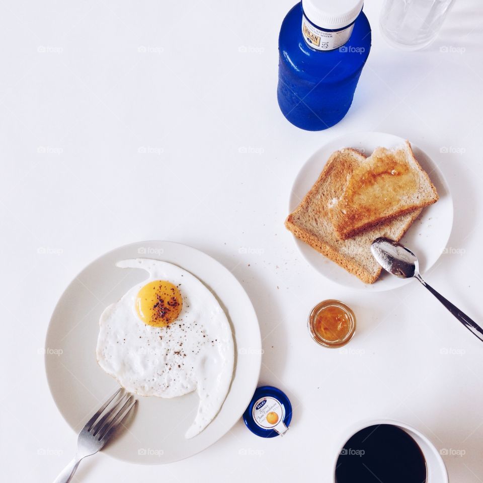 Daily breakfast . Daily breakfast with fried egg wholewheat toasts and black coffee 