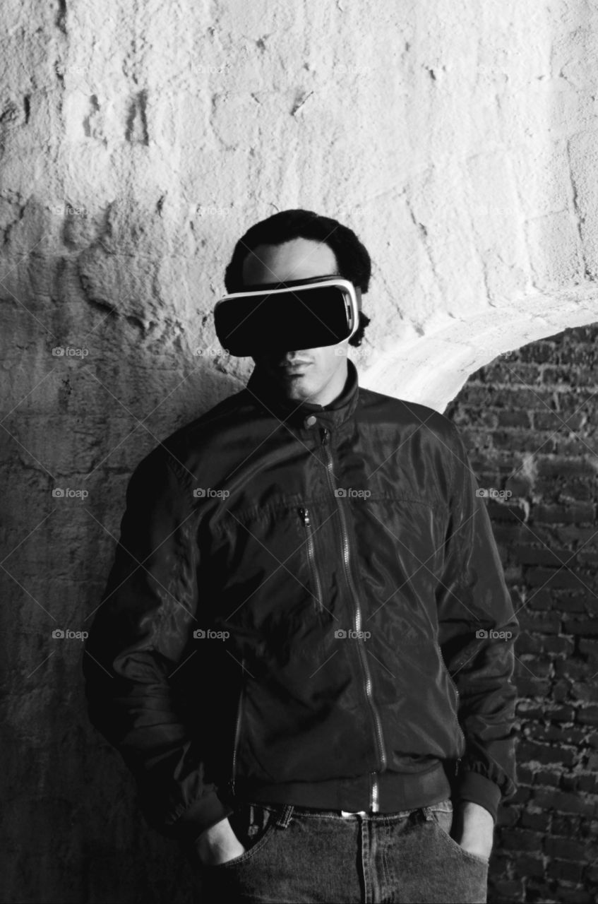 A young virtually transported stands in a old retro slave holding cell in downtown historic Savannah, Georgia.