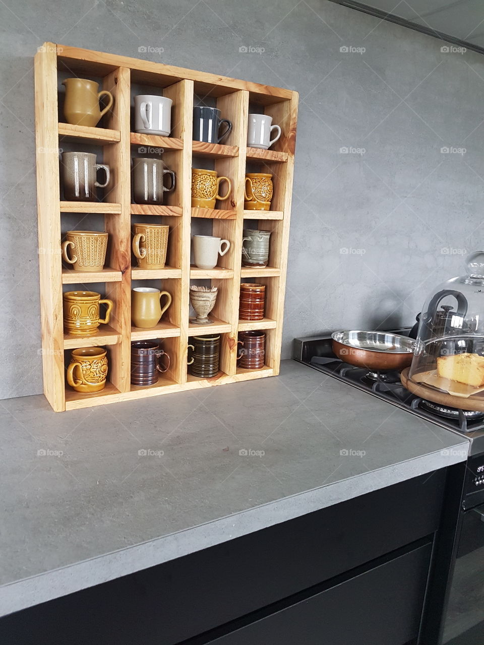 Wooden shelf with mug collection in kitchen