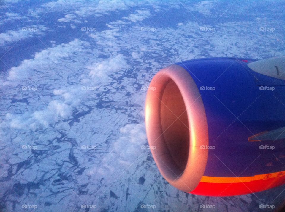 Sunsetting on Southwest jet motor with clouds 