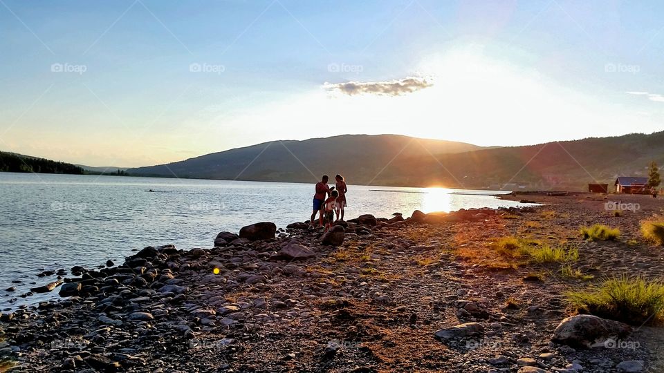 Family moment at beach, in the sunset.