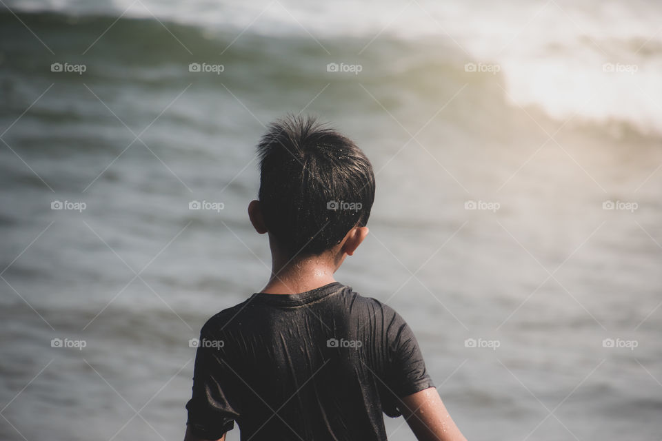 My boy facing the sea on the beach, it was a holiday season and we decided to go to the beach and spending the night there