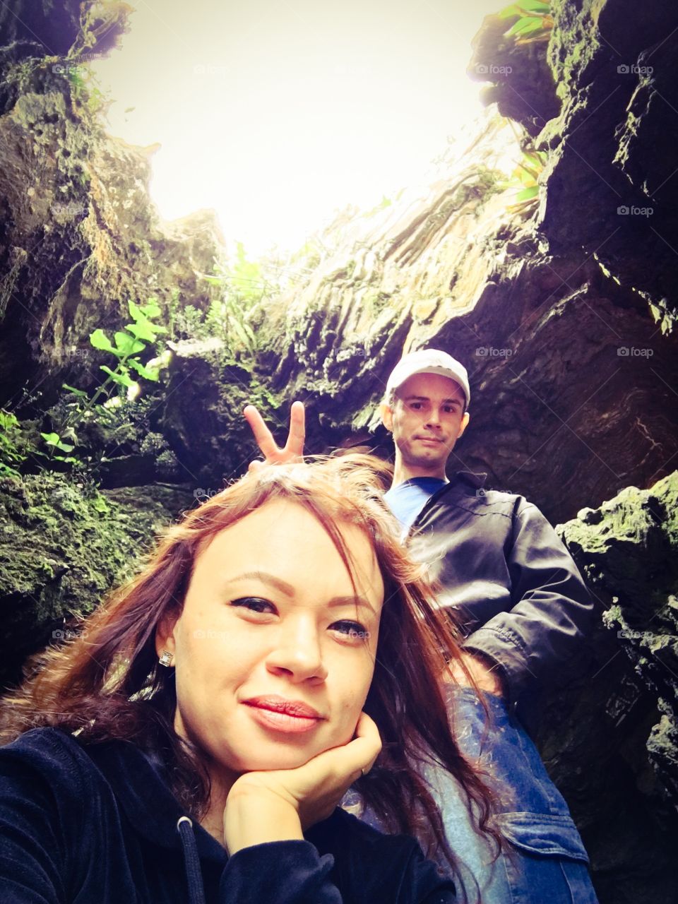 Couple at mountain with victory sign