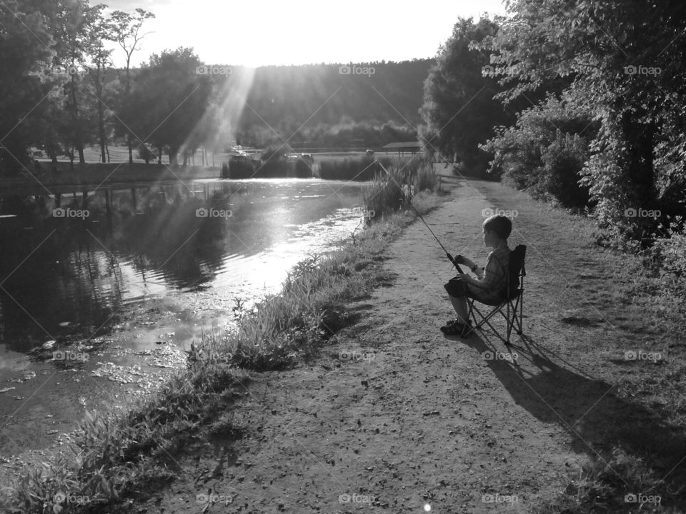 Boy fishing at river side