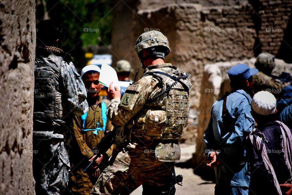 Anybody Home?. Soldiers meeting with local nationals to collect information on the Taliban in Kabul Afghanistan 