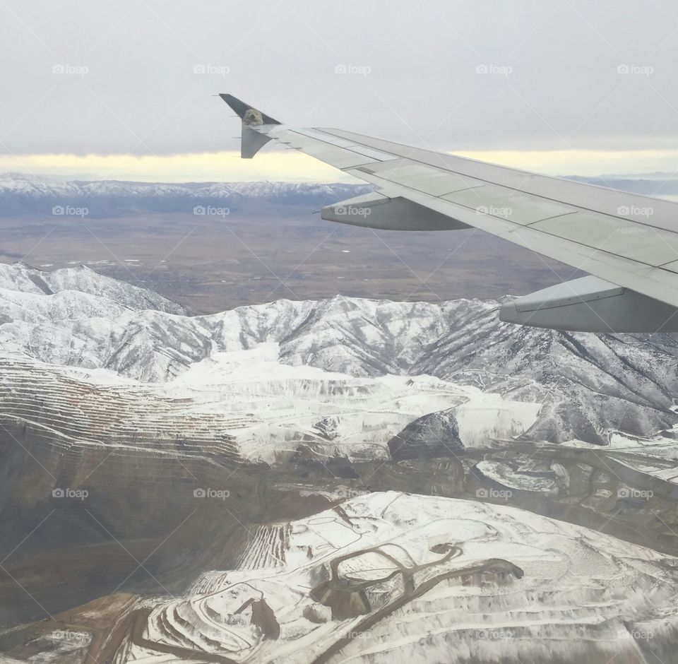 Aerial view in a plane over the mining towns near Salt Lake City Utah during winter. recent snowfall turned the mountains a powdery white.