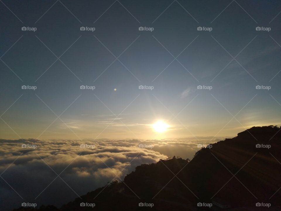 The sunrise in the sea clouds.