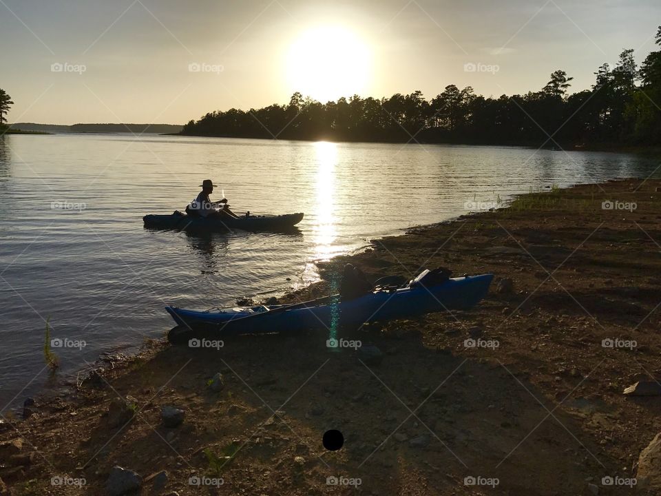 Launching kayaks at sunset