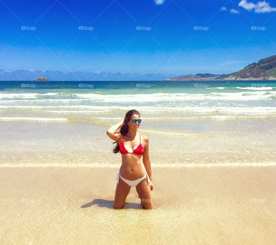 Happy woman in bikini at beach