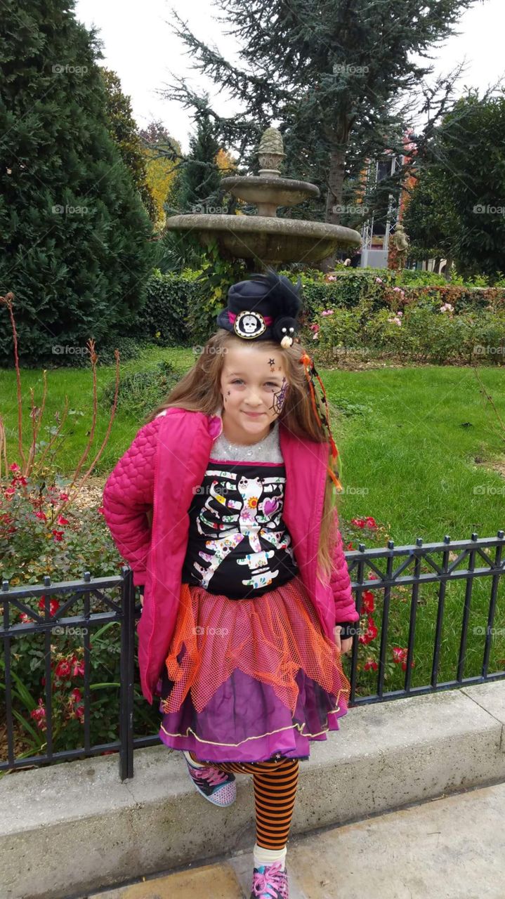 little girl in Disney land dressed for Halloween