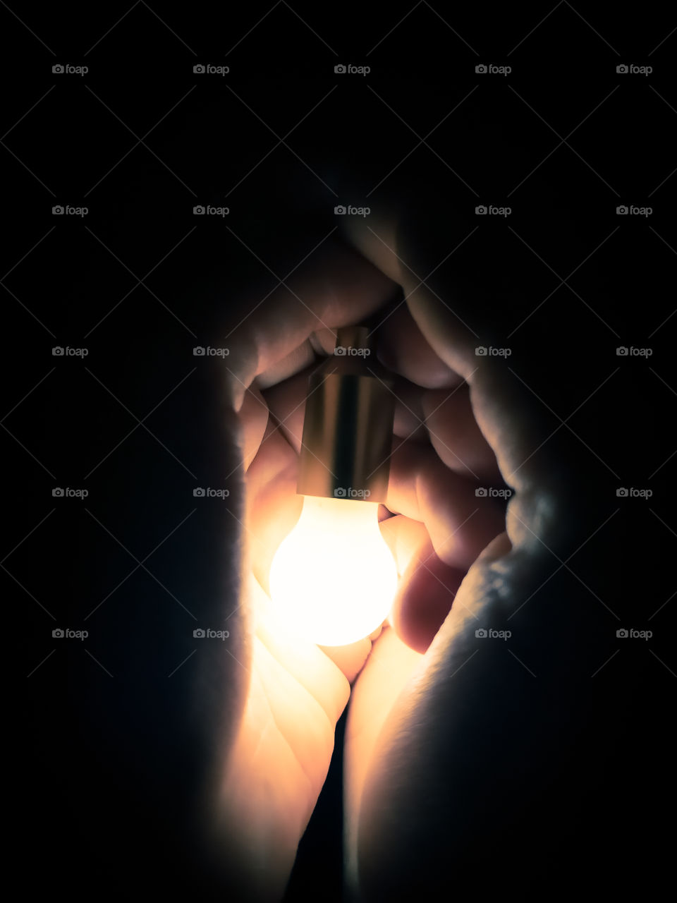 The bulb burning in a hand