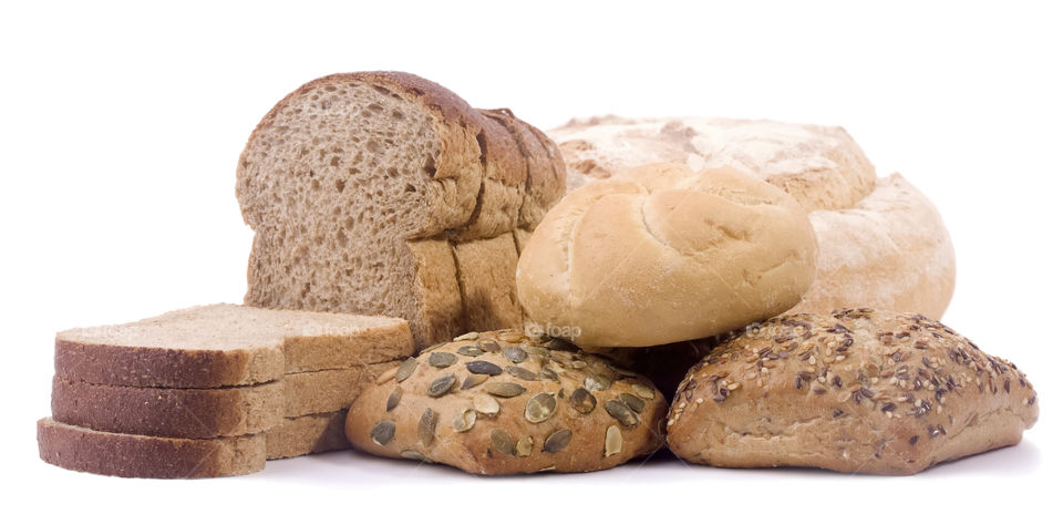 Composition of bread and slices of bread on white background