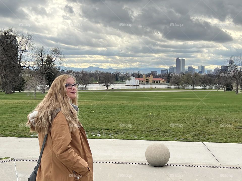 A woman with long blonde wavy hair exploring a new city while one vacation 