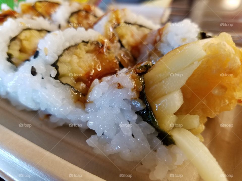 Extreme close-up of tempura shrimp sushi.
