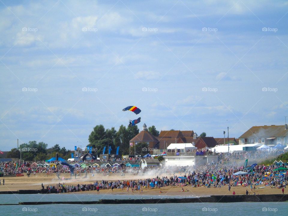 Parachute landing beetwen watching crowd on the Clacton beach, UK