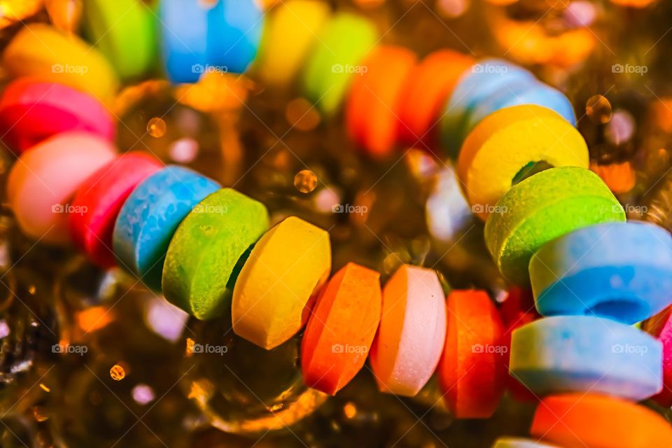 Up close and personal macro of a favorite of childhood, the colorful and delicious candy necklace , sweet and tart