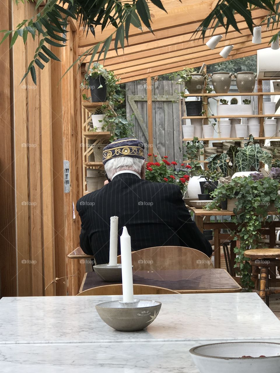 Beautiful old man sitting in a cafe