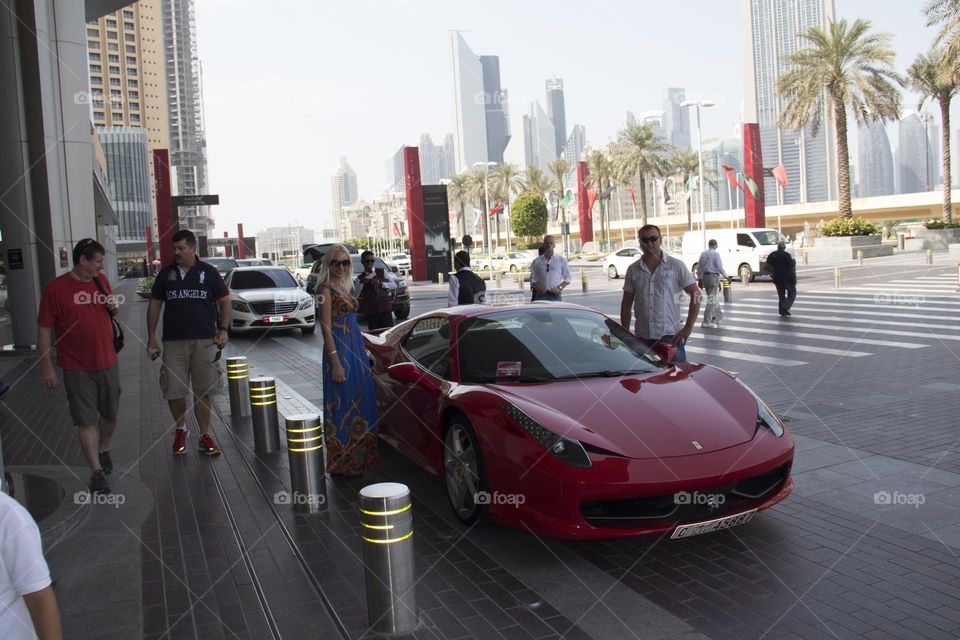 A Ferrari sports car in a modern city in the parking lot.