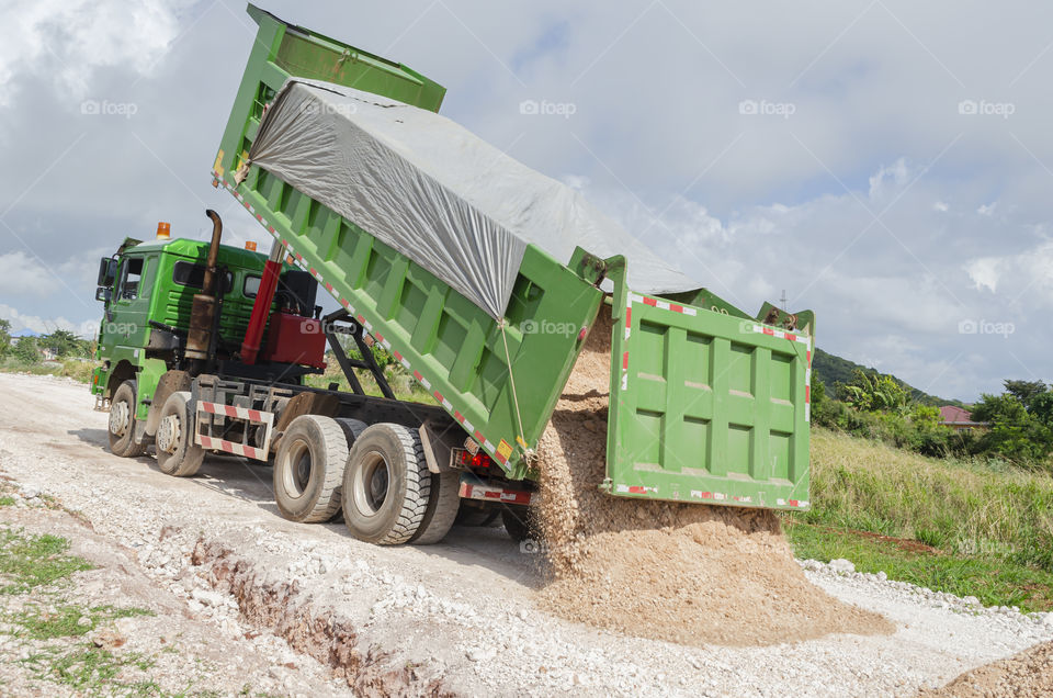 Marl Running Out Of Tipper Body Of Truck