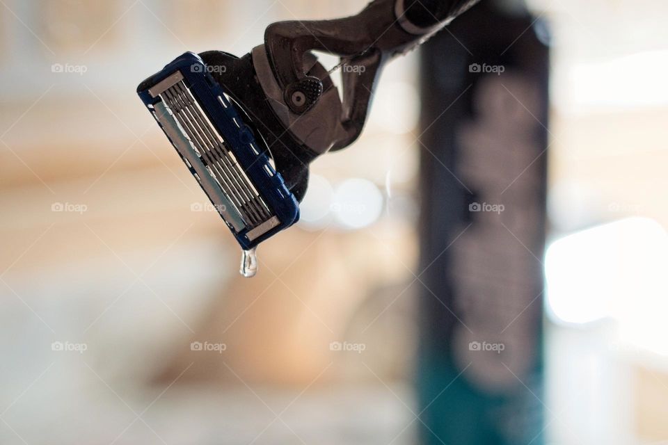 Shaving cream and razor blade with a water droplet