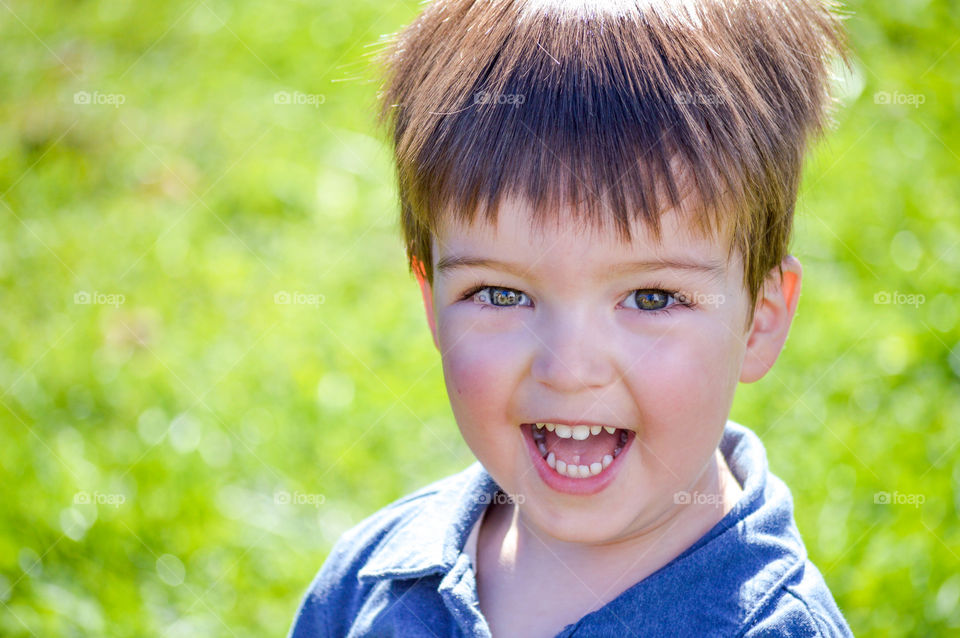 Close-up of a toddler boy's smiling face