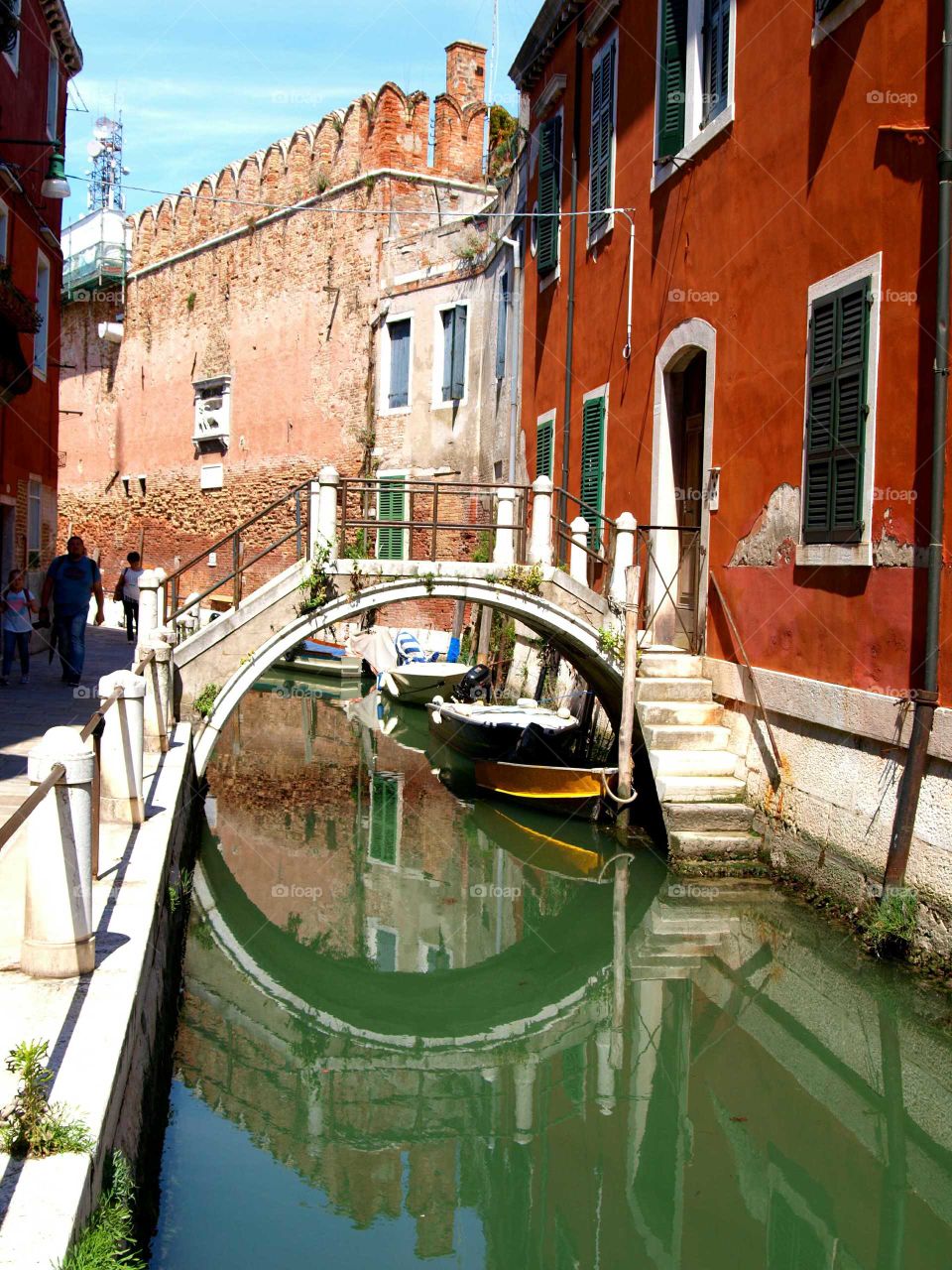 reflection of a red house in a canal